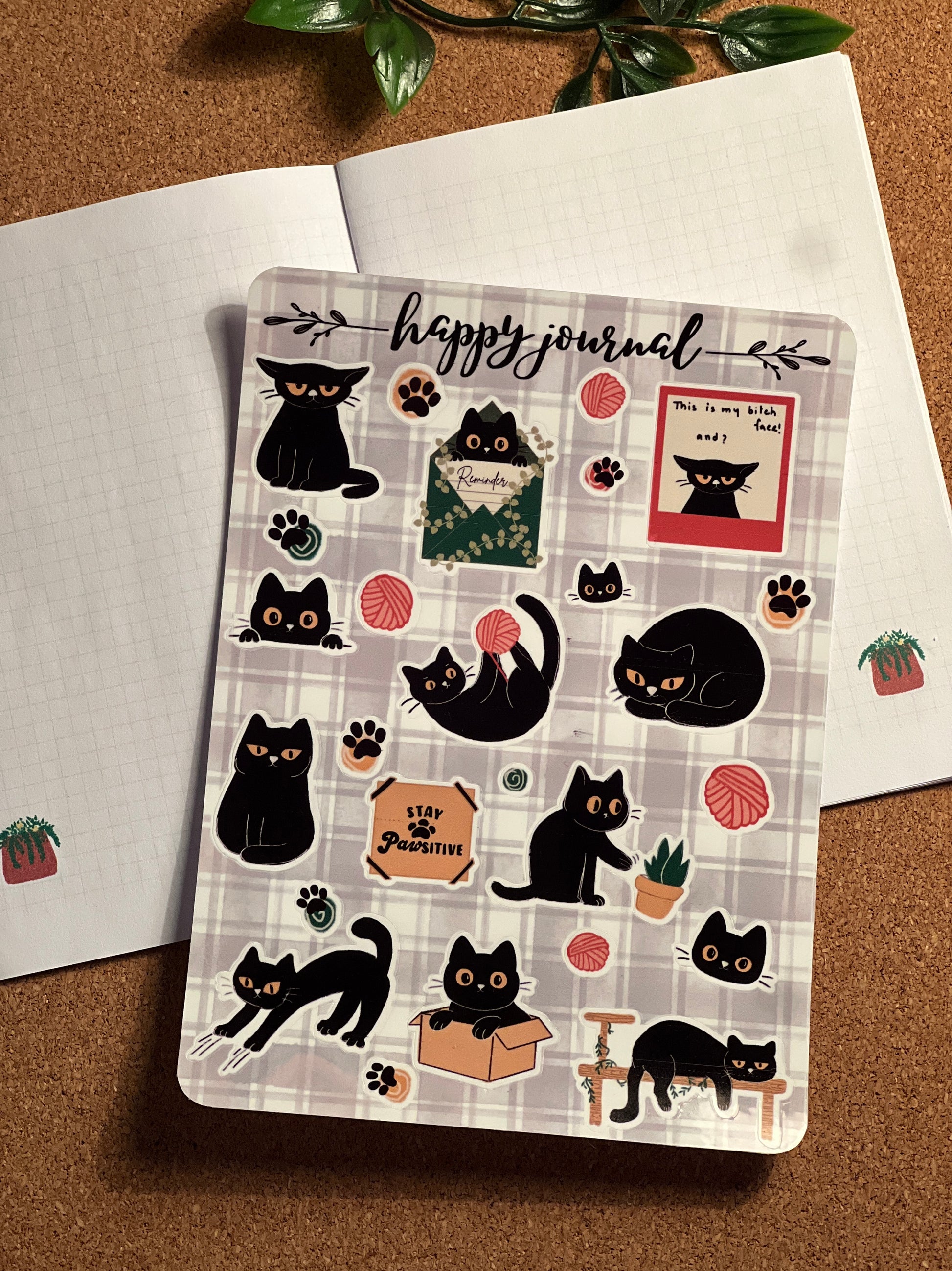 Happy Journal with black cat illustrations on a cork background