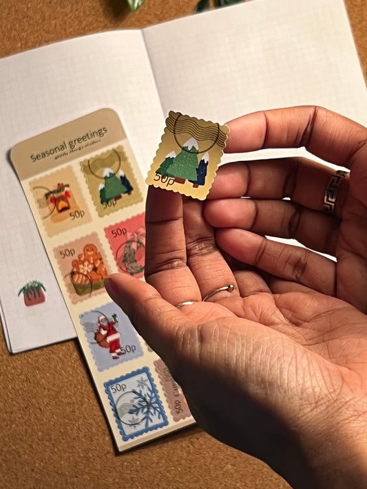 Close-up of hands holding a small collection of colorful stamps.