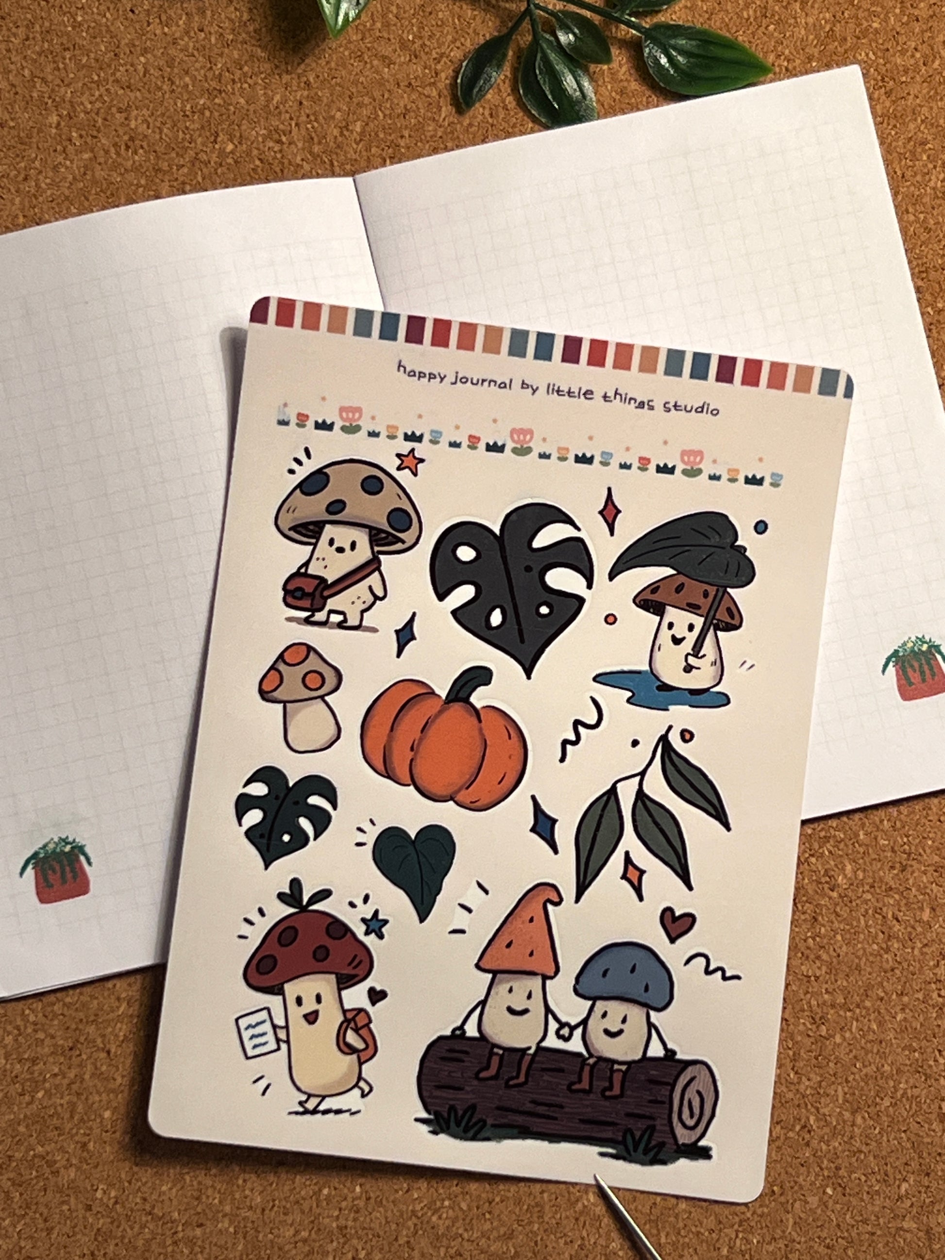 Sheet of autumn-themed stickers with pumpkins, leaves, and other fall elements on a cork background.