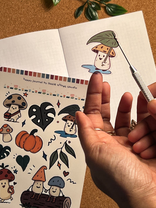 Hand holding a tattoo design with a color swatch on a wooden surface